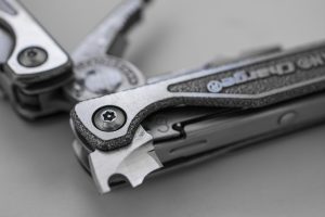 Comparison of Leatherman Charge TTi and Free P4 multitools showing their differences in design and features.